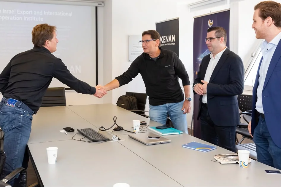 Two business partners shaking hands at the start of a meeting